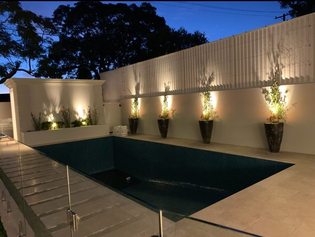 Pool area with garden feature lighting